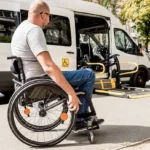 Staff assisting customer to get into a wheelchair taxi