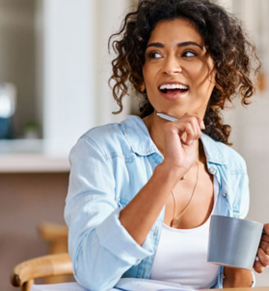 similing lady with a coffee mug in hand