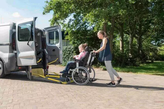 Women assisting person with wheelchair needs